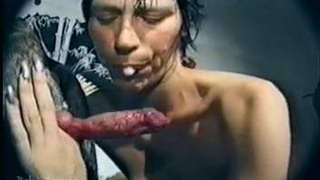 Brunette with short hair gets double penetration from a dog and a large dildo