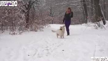 Flashy blonde getting fucked by a dog in the snow
