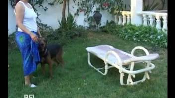 Black girl and her man have sex with dog in open air