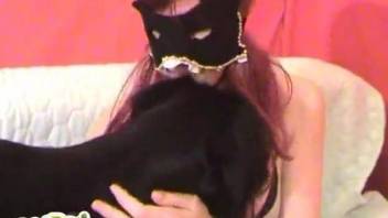 Masked redhead makes out with her horny dog